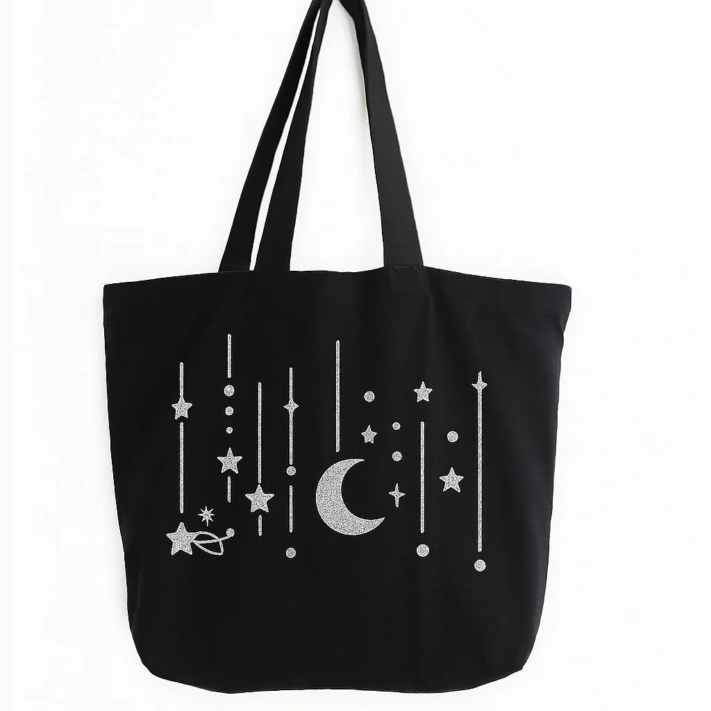 Black cotton tote bag with white crescent moon and hanging stars design, reusable Islamic shoulder bag for Ramadan, Eid, and everyday use