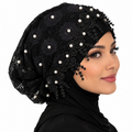 Black pearl lace hijab cap with floral lace, pearl embellishments, and decorative beaded trim worn by a model on a white background