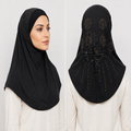 Black rhinestone lace one-piece hijab on a model showing front coverage and decorative lace and rhinestone detailing on the back.