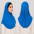 Blue rhinestone lace one-piece hijab on a model showing front coverage and decorative floral lace and rhinestone detailing on the back.