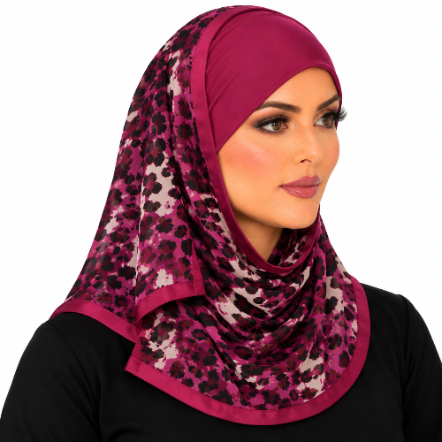 Woman wearing a burgundy headpiece with an attached burgundy and black printed scarf