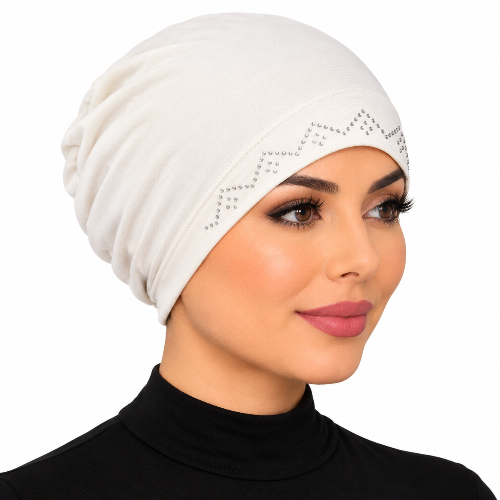 Woman modeling a cream stretch cap hijab with silver rhinestone zigzag trim on a white background.