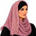 Woman wearing a dusty rose chiffon hijab with sparkling rhinestone details and black undercap