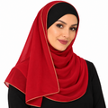 Woman wearing a red hijab scarf with thin light gold trim on a white background