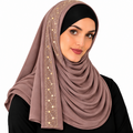 Woman wearing a brown rhinestone jersey hijab with gold rhinestone trim