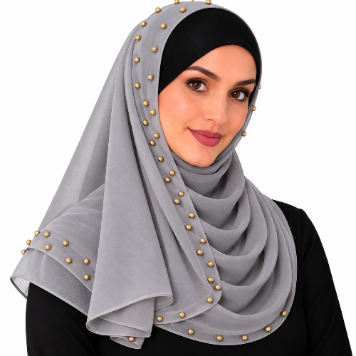 Woman wearing a grey chiffon hijab scarf with small gold beads on a white background
