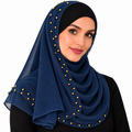 Woman wearing a navy-blue chiffon hijab scarf with small gold beads on a white background