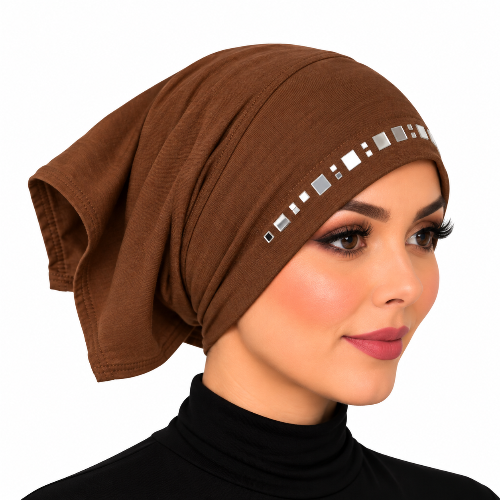 A woman wearing a brown fabric headscarf or hijab with a decorative row of small square metallic studs along the front edge, shown against a plain white background.