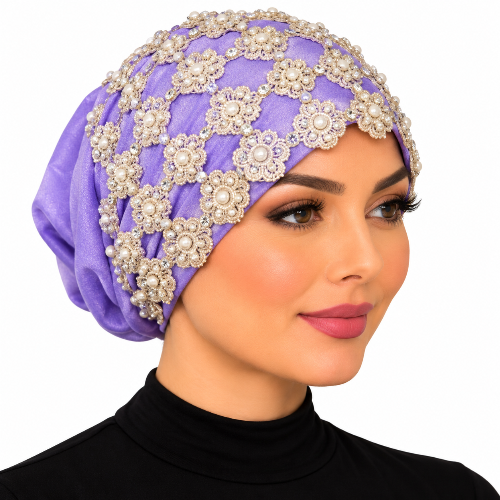 Woman modeling a purple embellished turban with gold floral lace, pearl beads, and decorative detailing on a white background.