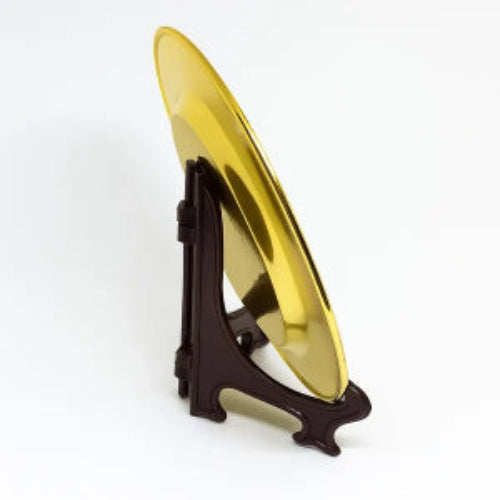 Gold circular object on a black stand against a white background