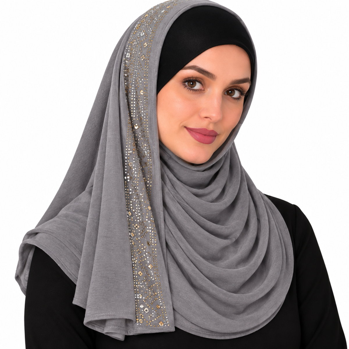 Woman wearing a grey jersey hijab with rhinestone trim along one side