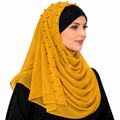 Mustard yellow chiffon hijab with gold bead details worn by a model