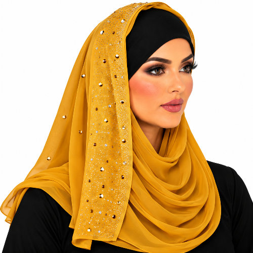 A woman wearing a mustard yellow hijab with rhinestone embellishments on the side panel, paired with a black undercap and black top, against a plain white background.