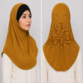 Mustard rhinestone lace one-piece hijab on a model showing front coverage and decorative floral lace and rhinestone detailing on the back.