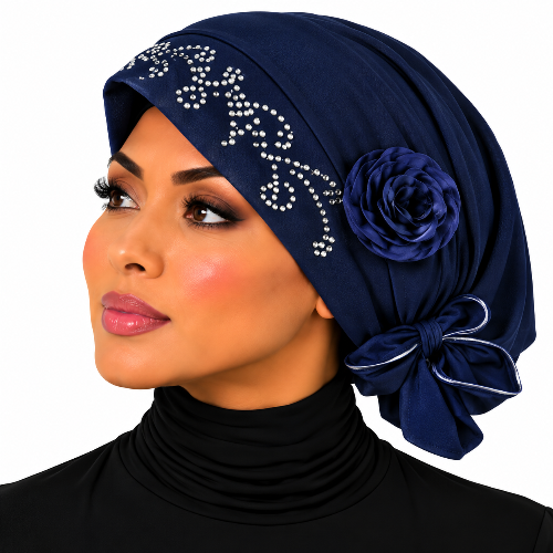 Woman wearing a navy rhinestone flower turban headwrap with navy flower and bow detail