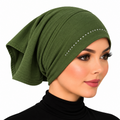 An olive green fabric headscarf or hijab with a curved line of small white rhinestones, modeled on a woman against a plain white background.