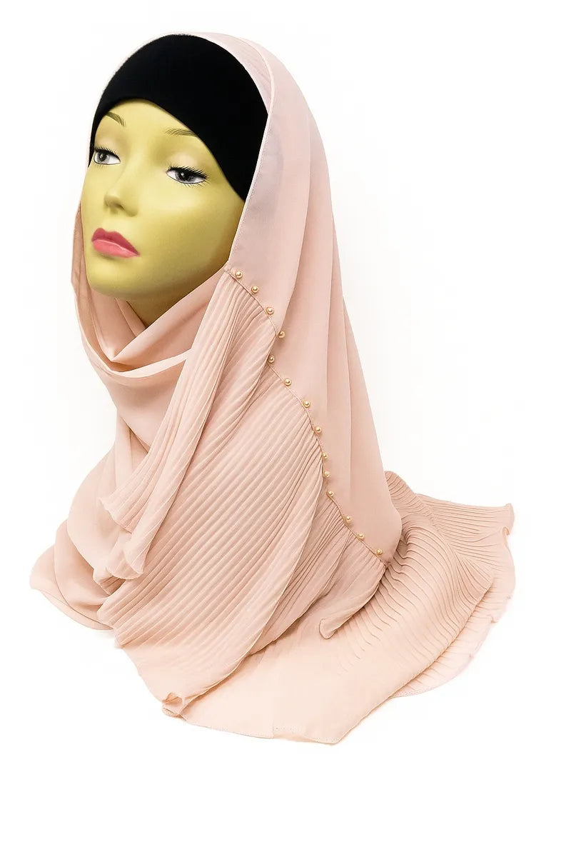 Peach chiffon hijab scarf made from lightweight airy fabric, elegant modest Muslim headscarf draped on mannequin for stylish everyday hijab wear.