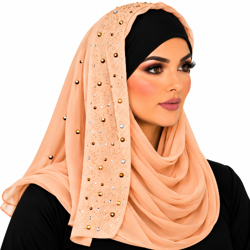 Woman wearing a peach chiffon hijab with sparkling rhinestone details and a black undercap