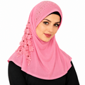 Woman wearing a light pink one-piece instant khimar hijab with a smooth front and comfortable neck coverage.