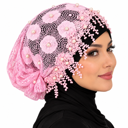 Pink pearl lace hijab cap with floral lace, pearl embellishments, and decorative beaded trim worn by a model on a white background.