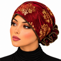 Woman wearing a red turban with elegant gold floral patterns and gathered back detail