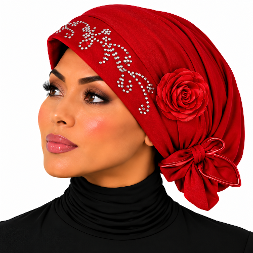 A woman shown in profile wearing a bright red hijab with rhinestone embellishments and a large fabric rose decoration, paired with a black turtleneck against a plain white background.