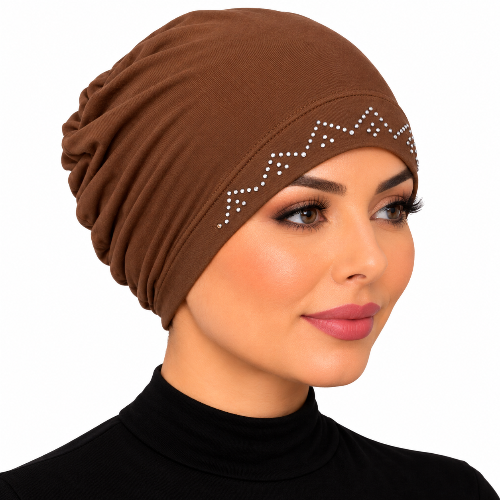 Woman modeling a brown embellished stretch cap hijab with silver rhinestone zigzag trim on a white background.