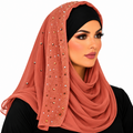 Woman wearing a rust chiffon hijab with sparkling rhinestone details and a black undercap