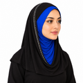 A woman wearing a black hijab with a bright blue inner head covering and silver rhinestone trim along the edge, shown against a plain white background.